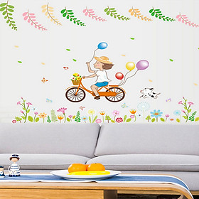 Decal dán tường bé trai đạp xe cầm bóng bay sắc màu