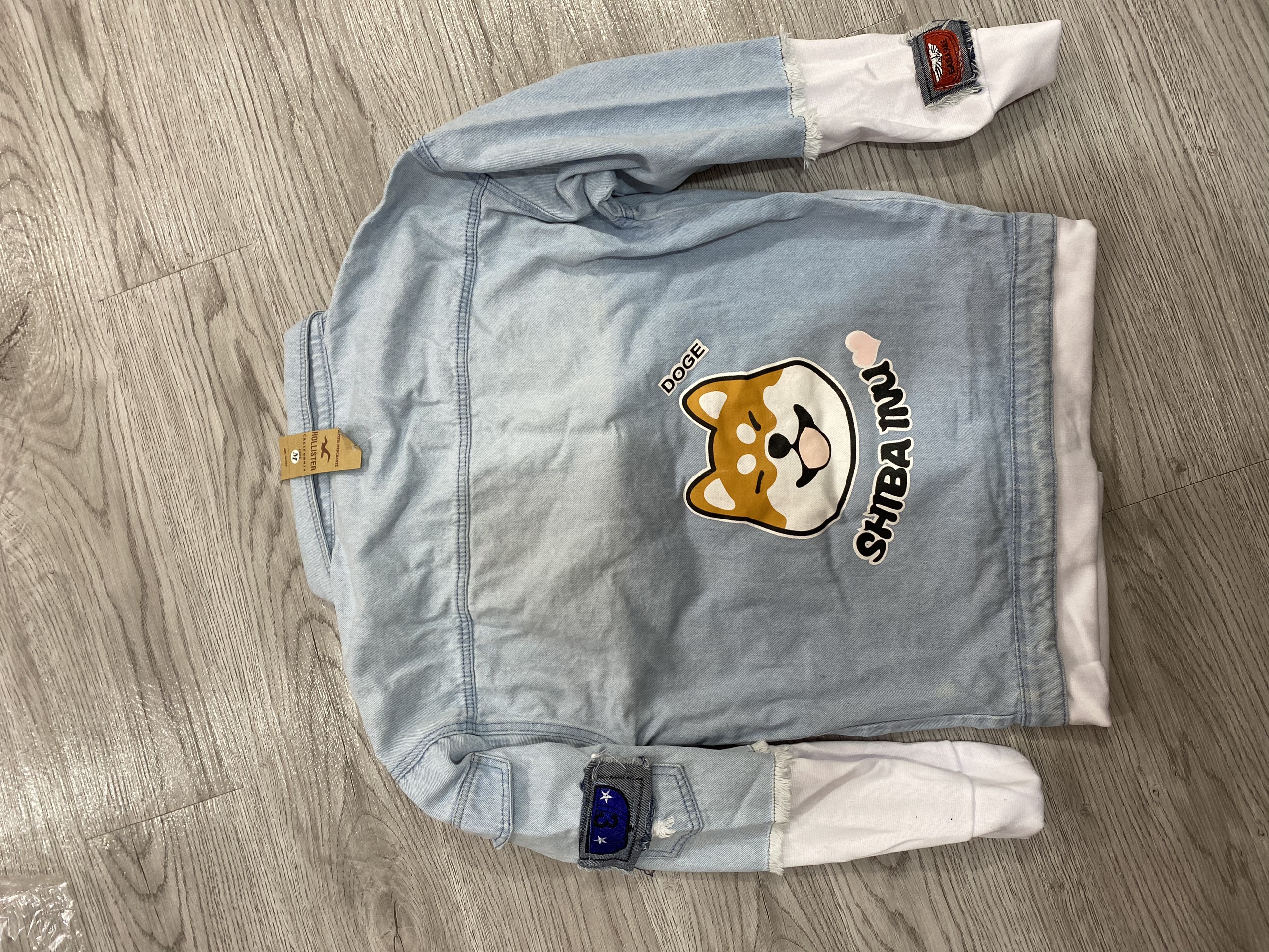 Hình ảnh Áo khoác jeans nam in hình cún dễ thương mặt cười , áo khoác nam form vừa phối nỉ mềm co dãn lôi cuốn có mũ có 3 size Julido mẫu khoác AKJ8686 - Màu Xanh Hình ảnh Áo khoác jeans nam in hình cún dễ thương mặt cười , áo khoác nam form vừa phối nỉ mềm co dãn lôi cuốn có mũ có 3 size Julido mẫu khoác AKJ8686 - Màu Xanh