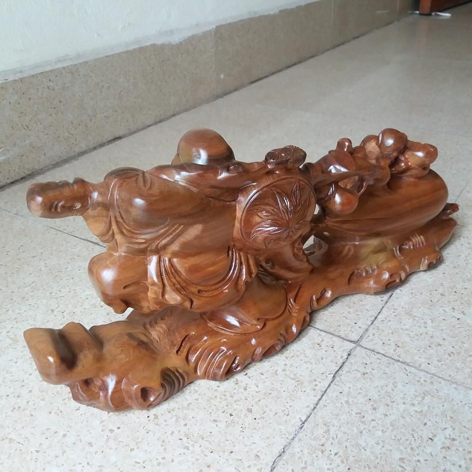 Tượng di lạc kéo bao .gỗ bách sanh -kích thước cao 19cmx40cmx11cm