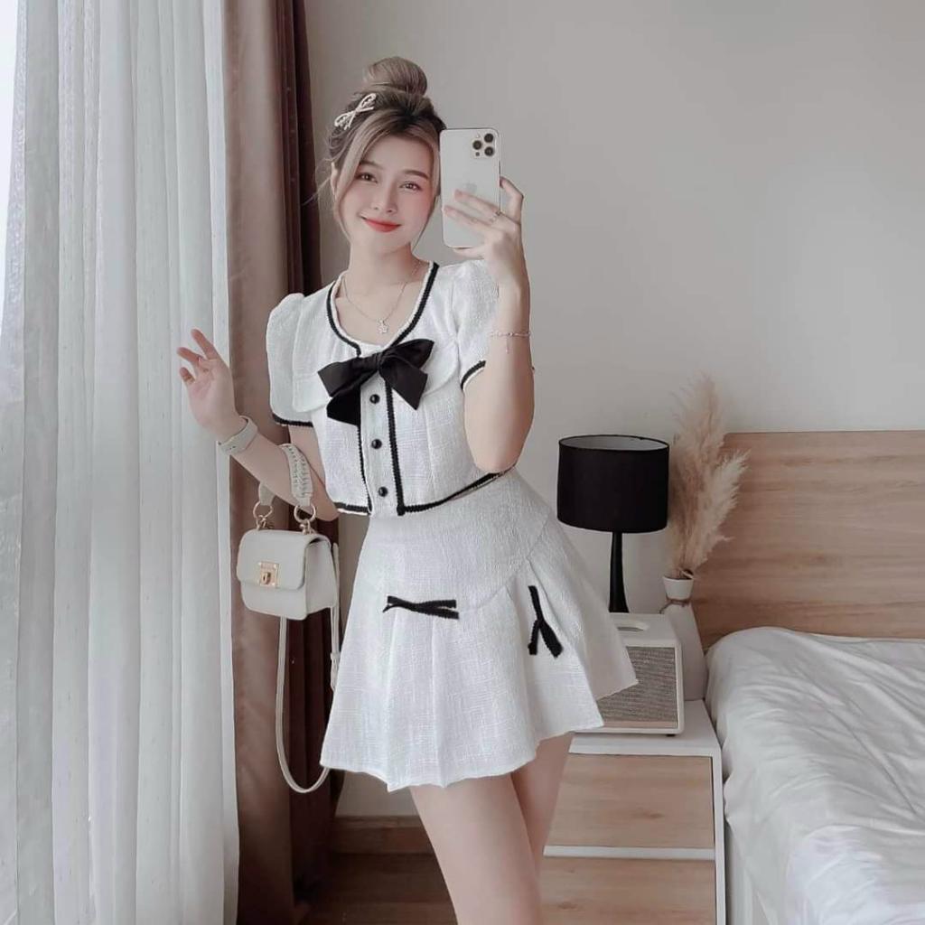 Sét áo lửng viền lai đính nơ cài nút kèm chân váy xoè