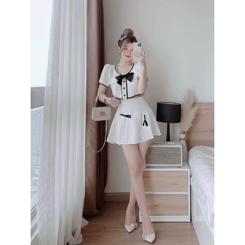 Sét áo lửng viền lai đính nơ cài nút kèm chân váy xoè