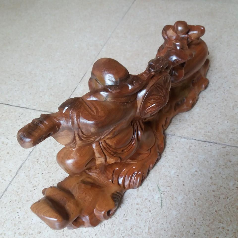 Tượng di lạc kéo bao .gỗ bách sanh -kích thước cao 19cmx40cmx11cm
