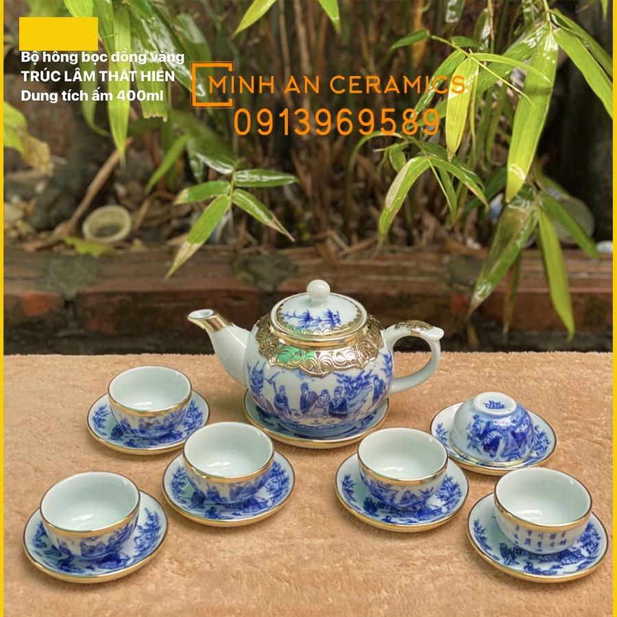 Bộ ấm trà gốm sứ Bát tràng men lam vẽ trúc lâm thất hiền bọc đồng vàng gốm Minh An Bát Tràng dáng ấm quả hồng