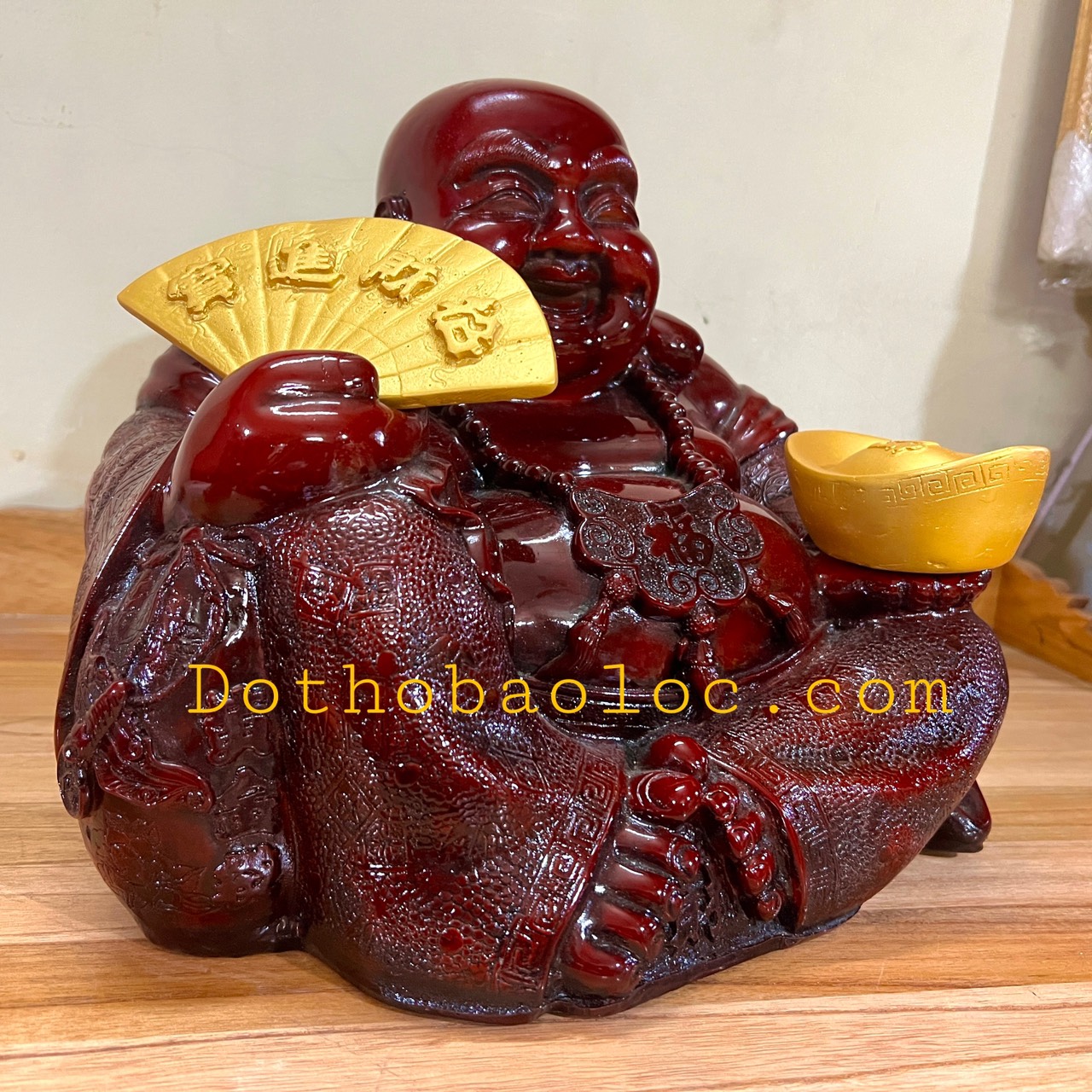 Tượng Di Lặc bột đá màu gỗ tay cầm quạt và thỏi vàng cao 27cm