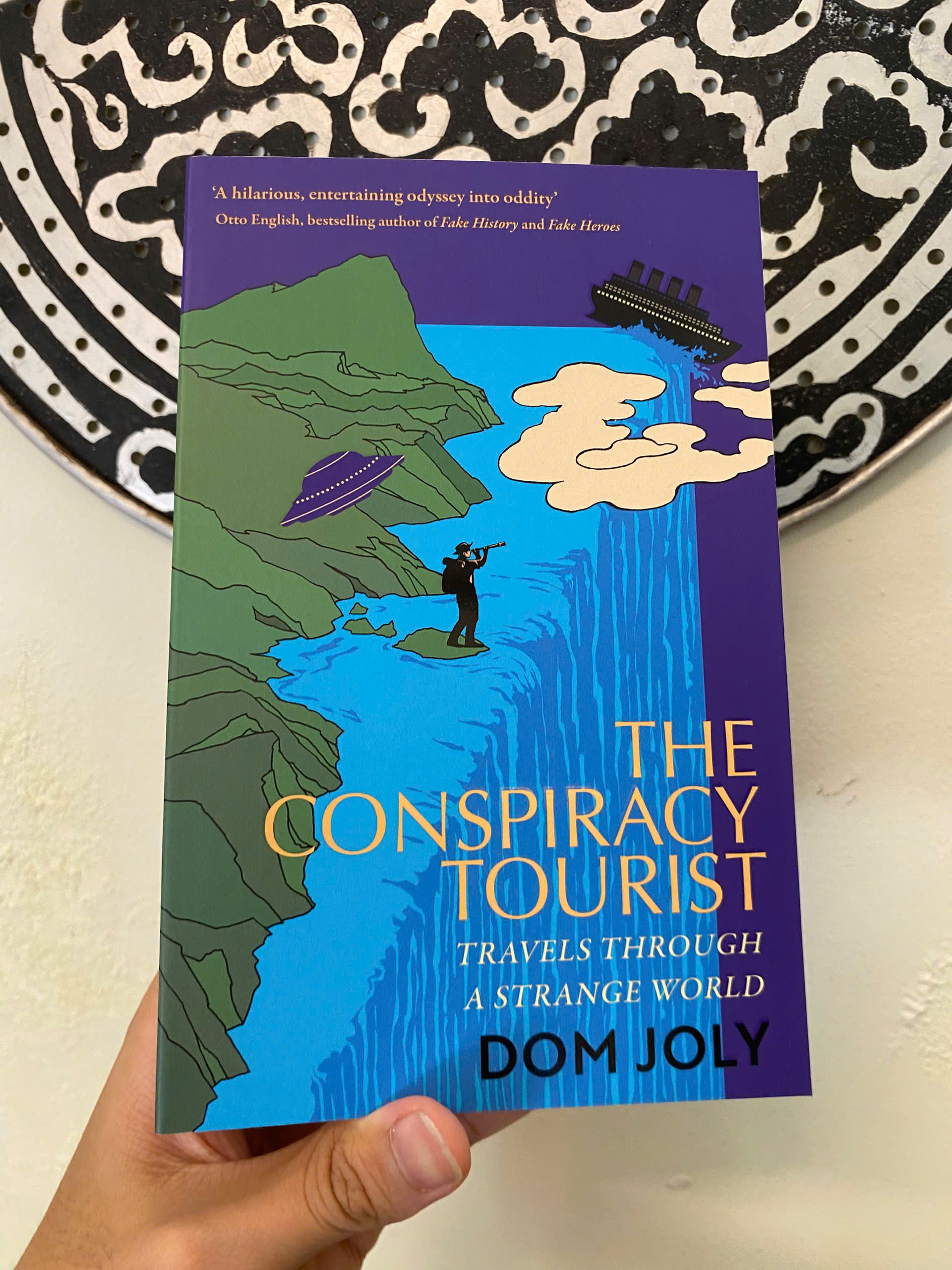 Sách - The Conspiracy Tourist: Travels Through a Strange World by Dom Joly | Travel Nonfiction