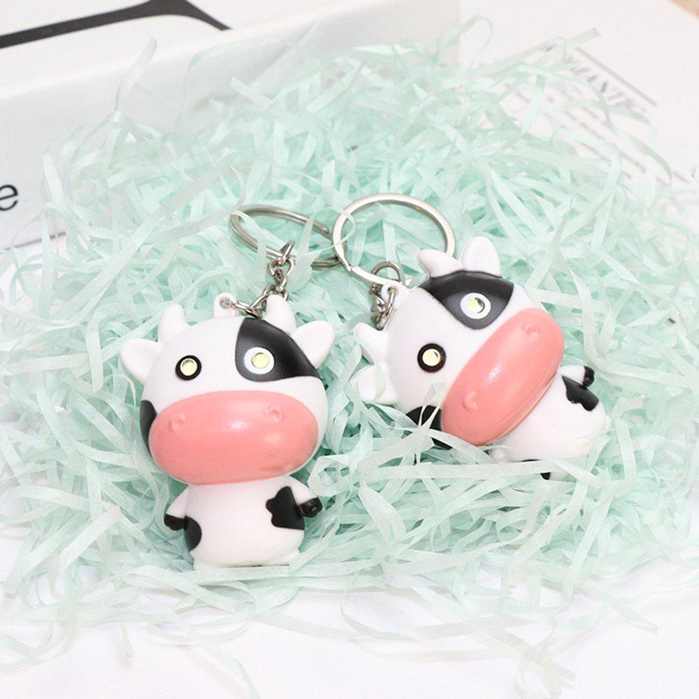 Móc khóa con bò sữa có đèn led phát nhạc treo xe máy balo cặp túi xách cute dễ thương