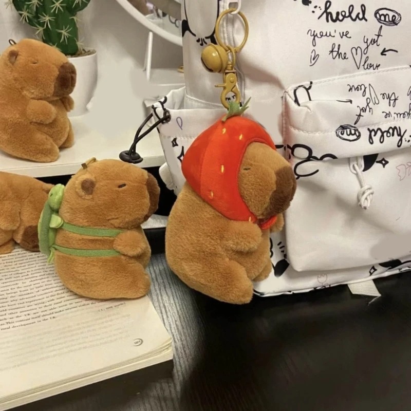 Móc khoá Capybara 12 cm vô tri hài hước, thú nhồi bông chuột lang nhiều mẫu mã đeo balo, đội mũ dâu, gấu bông Capybara có tóc Hồng Nâu