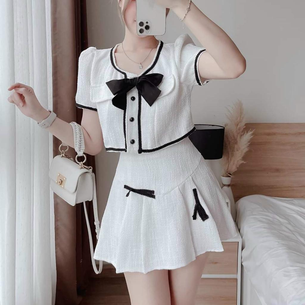 Sét áo lửng viền lai đính nơ cài nút kèm chân váy xoè