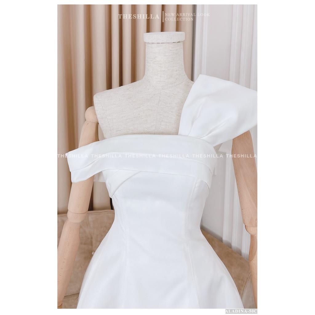 Váy thiết kế cao cấp màu trắng lệch vai phối nơ trên ngực The Shilla - Aladina-50C0