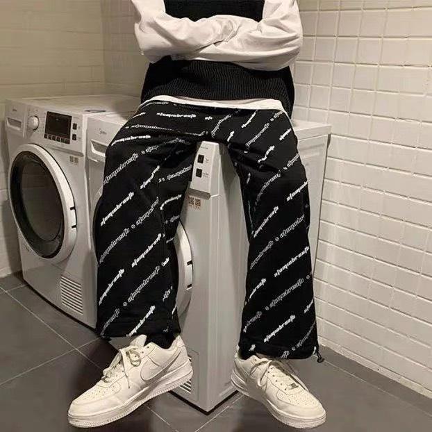 Quần jogger nữ chốt gấu hoạ tiết chữ chéo freesize ống rộng