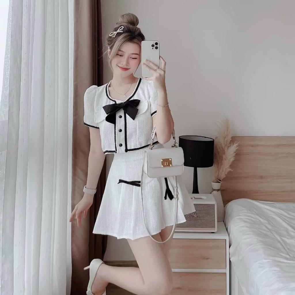 Sét áo lửng viền lai đính nơ cài nút kèm chân váy xoè