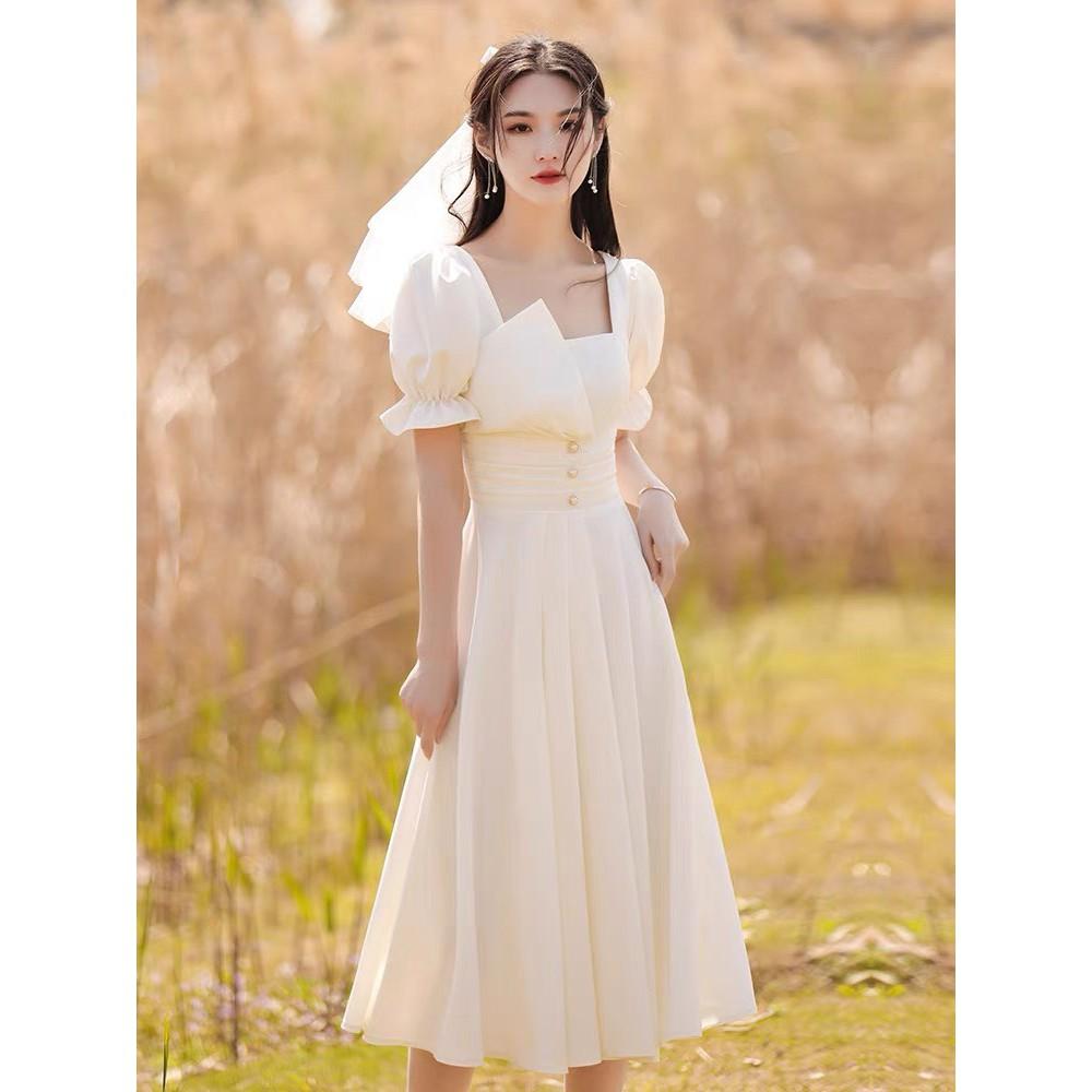 ĐẦM TRẮNG DỰ TIỆC VẢI MG 2 LỚP CỔ VUÔNG XẾP LY EO PHỐI NÚT CƯỜM TAY NGẮN BO CHUN DÁNG XÒE