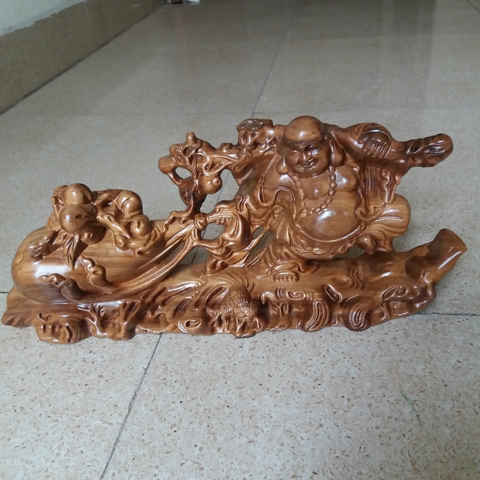 Tượng di lạc kéo bao .gỗ bách sanh -kích thước cao 19cmx40cmx11cm
