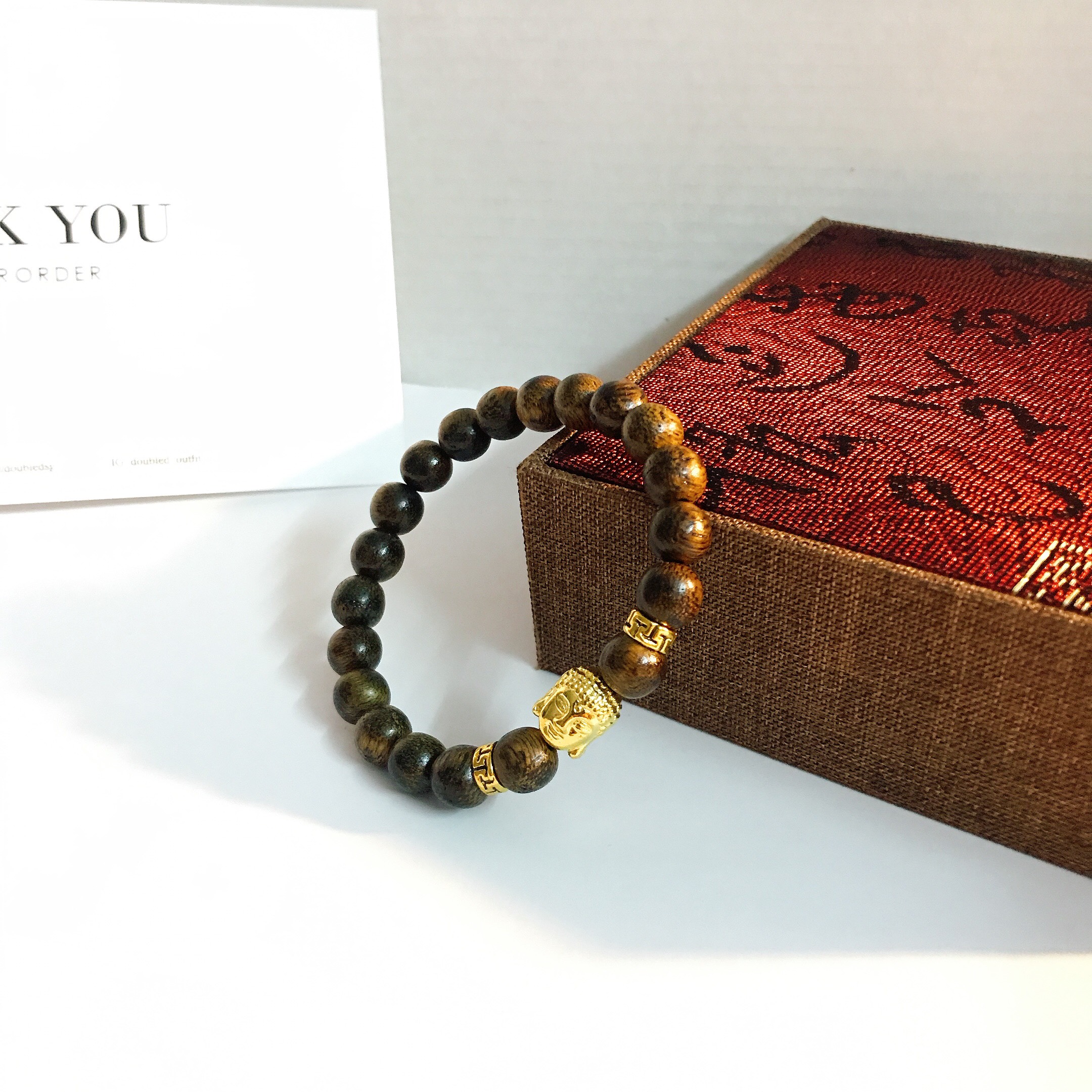 Vòng tay trầm hương mặt phật mạ vàng 18k