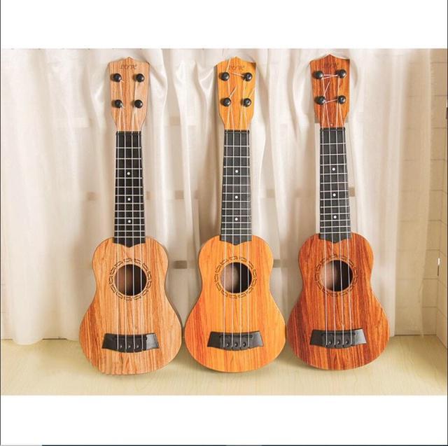 Đồ chơi đàn guitar mini vân gỗ cho trẻ tập chơi đàn