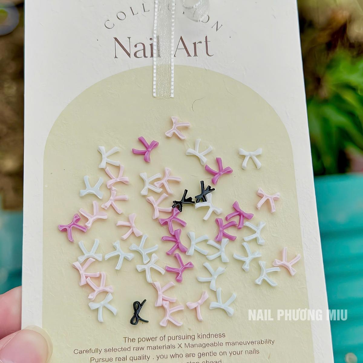 Set 50 Chiếc Charm Nơ Nhựa Nổi 3D SJY Mẫu Mới Làm Nail Siêu Xinh, Nơ Nút Thắt Ruy Băng Mix Màu Trắng Hồng Đen Size Mini Trang Trí Móng Hàn Quốc