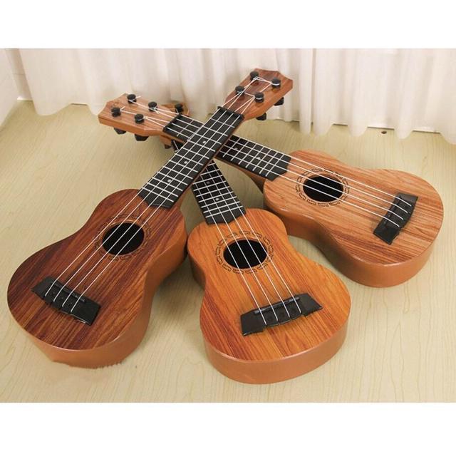 Đồ chơi đàn guitar mini vân gỗ cho trẻ tập chơi đàn