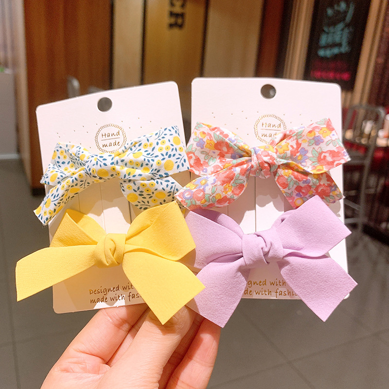 Kẹp tóc cho bé gái set 2 chiếc đính nơ rất dễ thương PK36 - Vàng