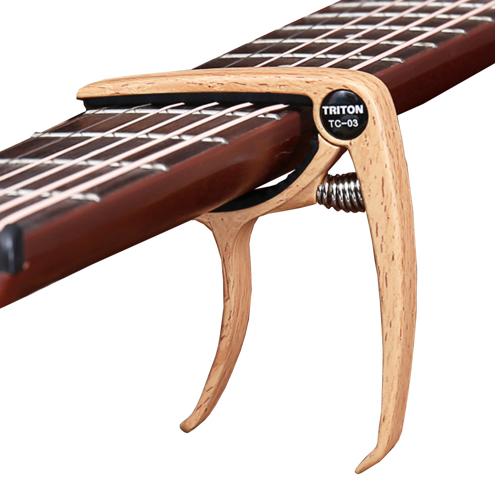 Capo Đàn Guitar/Ukulele Vân Gỗ Woim TC-03 ( Màu ngẫu nhiên )