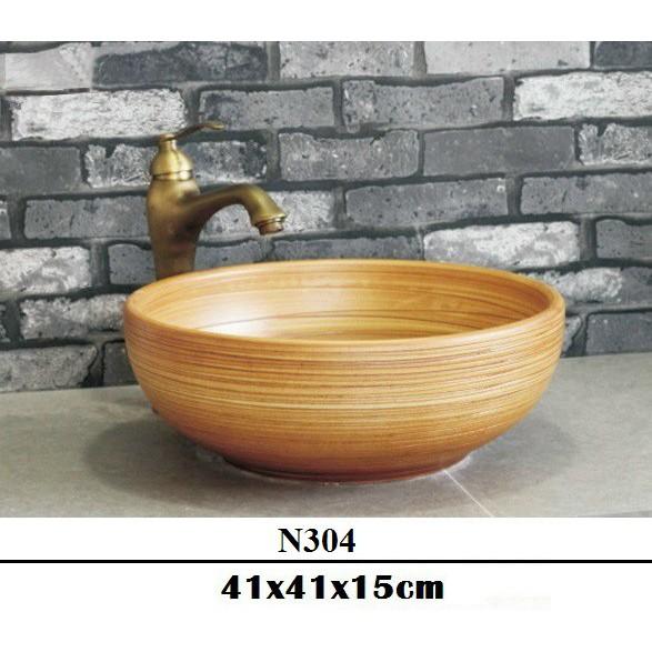 Chậu sứ lavabo để bàn hoa văn nghệ thuật với tông vàng chủ đạo