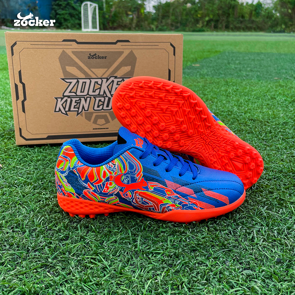 Giày đá bóng trẻ em Zocker Kiên Cường Royal Blue/Orange - Êm - Bền - Bảo Vệ Chân Tránh Chấn Thương Cho Bé Nhờ Công Nghệ Ma Sát Kép - Tặng Túi Chính Hãng