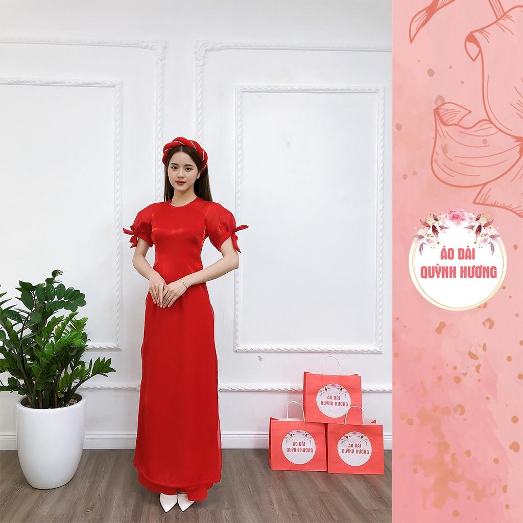 Áo dài màu đỏ chất voan tơ tay bồng buộc nơ cổ tròn