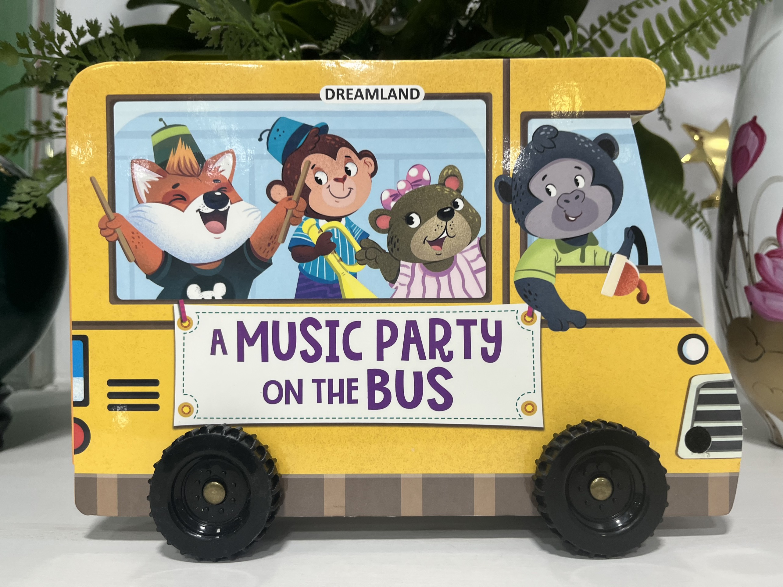 A Music Party On The Bus - A Shaped Board Book With Wheels (Bữa Tiệc Âm Nhạc Trên Xe Buýt)
