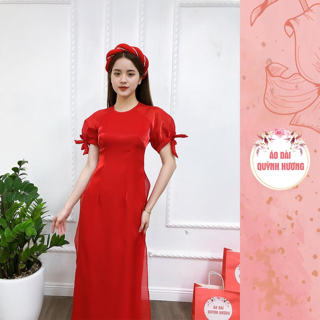 Áo dài màu đỏ chất voan tơ tay bồng buộc nơ cổ tròn