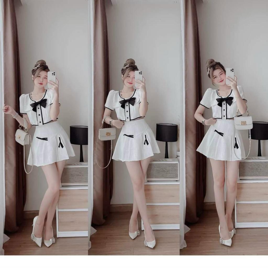 Sét áo lửng viền lai đính nơ cài nút kèm chân váy xoè