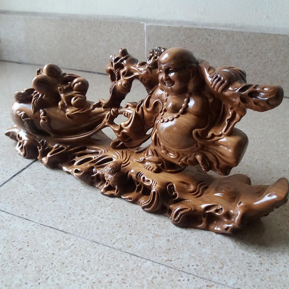 Tượng di lạc kéo bao .gỗ bách sanh -kích thước cao 19cmx40cmx11cm