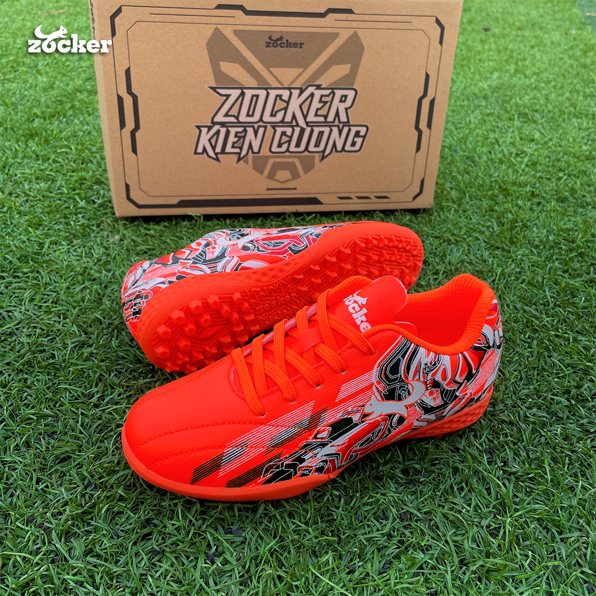 Giày đá bóng trẻ em Zocker Kiên Cường Orange/Black - Êm - Bền - Bảo Vệ Chân Tránh Chấn Thương Cho Bé Nhờ Công Nghệ Ma Sát Kép - Tặng Túi Chính Hãng